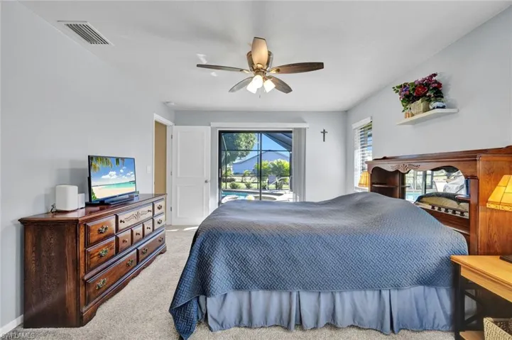 Bedroom with carpet floors, access to exterior, and a ceiling fan