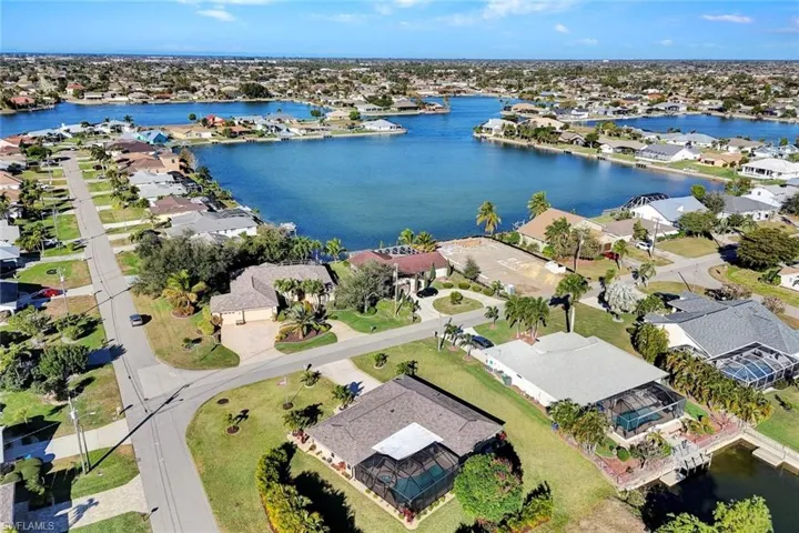 Aerial view of property's location with nearby suburban area and a nearby body of water