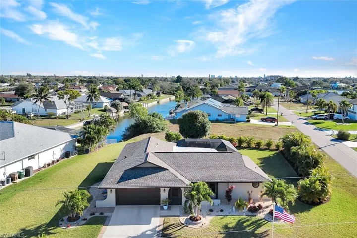 Aerial view of residential area featuring a large body of water