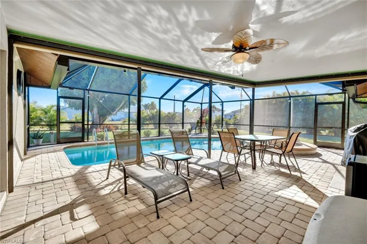 Sunroom featuring a patio and ceiling fan
