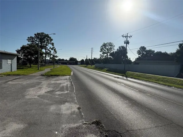 View of asphalt road with street lighting and sidewalks