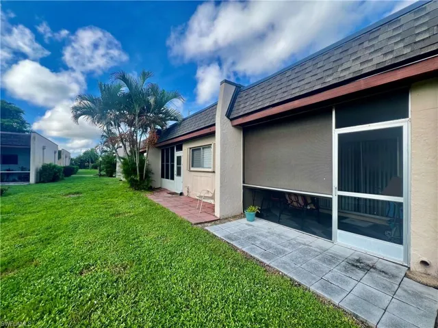 View of side of home with a lawn