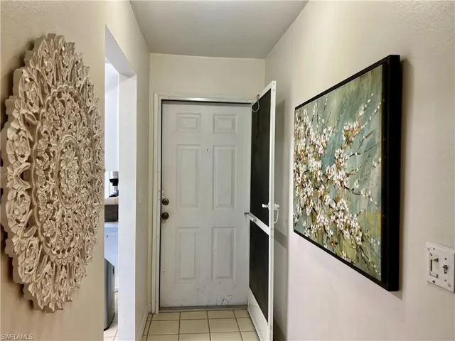 Doorway to outside featuring tile patterned floors