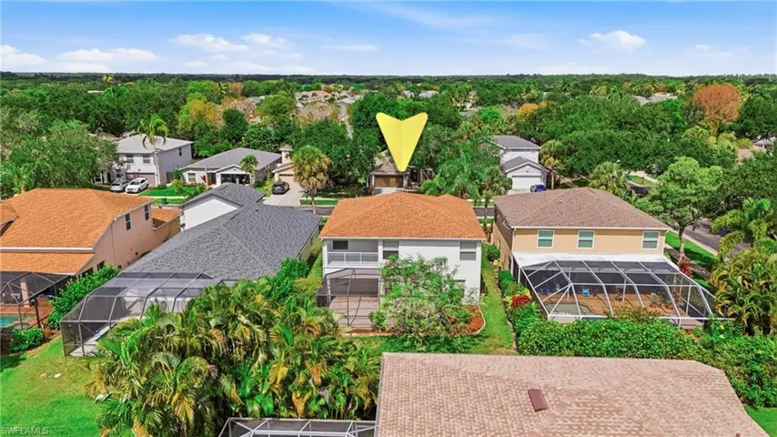 Two-story residence featuring a screened-in pool enclosure and an upper-level balcony