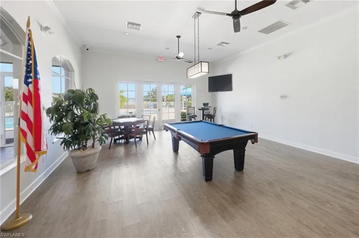 Expansive recreation room featuring wood-finish flooring, high ceilings, and a pool table