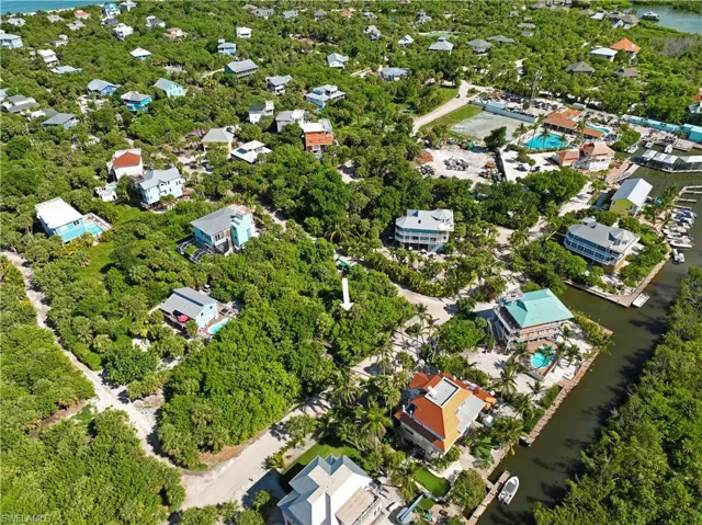 Birds eye view of property with a water view