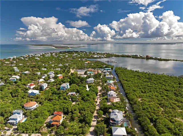 Birds eye view of property with a water view