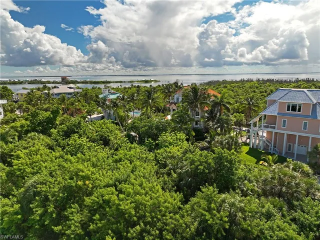Birds eye view of property with a water view
