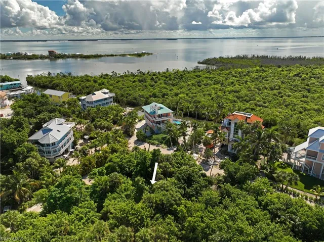 Birds eye view of property with a water view