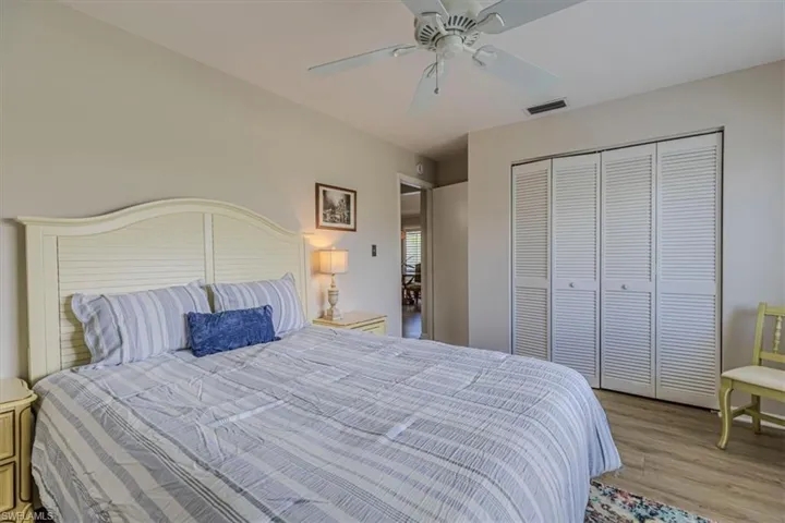 Guest Bedroom with ceiling fan, light wood-style floors, and a closet