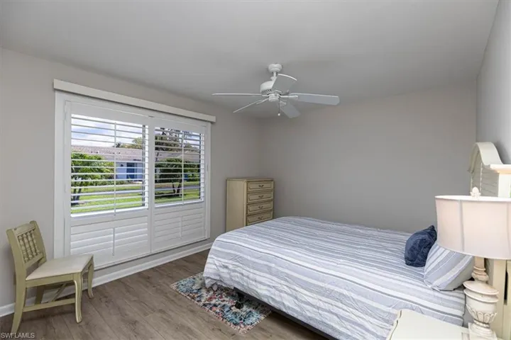 Guest Bedroom with light wood-style floors and ceiling fan
