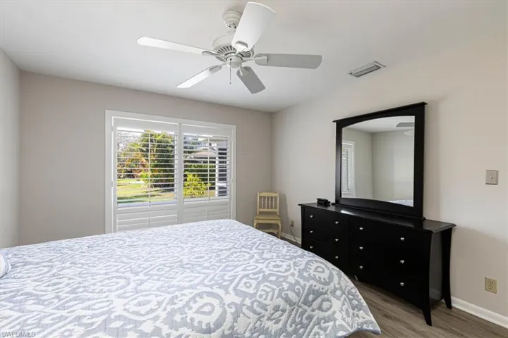 Primary Bedroom with a ceiling fan and light wood-style floors