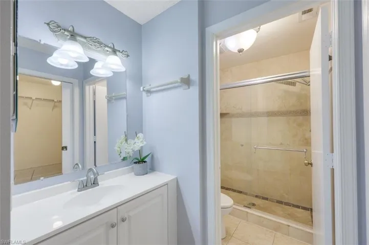 Features tiled walk in shower