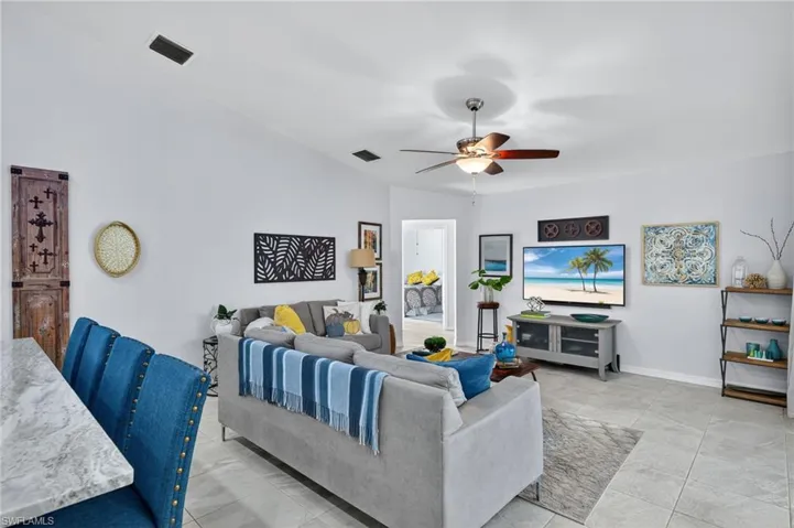Living room featuring a ceiling fan and baseboards
