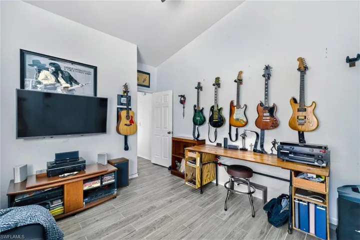 Office space featuring wood tiled floors and lofted ceiling
