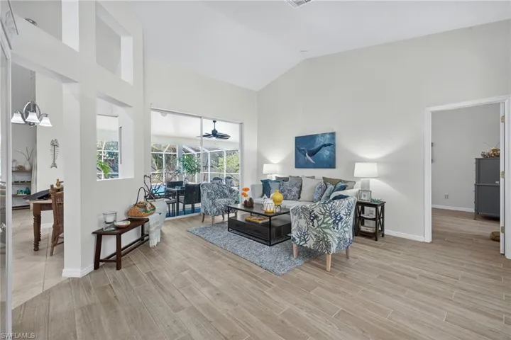 Living room with wood finish floors and lofted ceiling