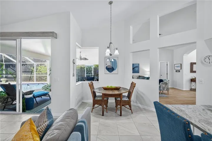 Dining area featuring vaulted ceiling and light tile patterned floors