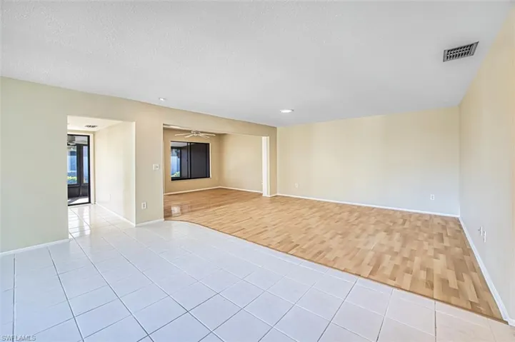 Spare room featuring a ceiling fan, a textured ceiling, and light wood-type flooring