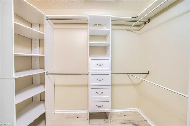Walk in closet featuring light wood-type flooring