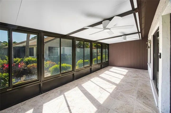 Unfurnished sunroom with ceiling fan
