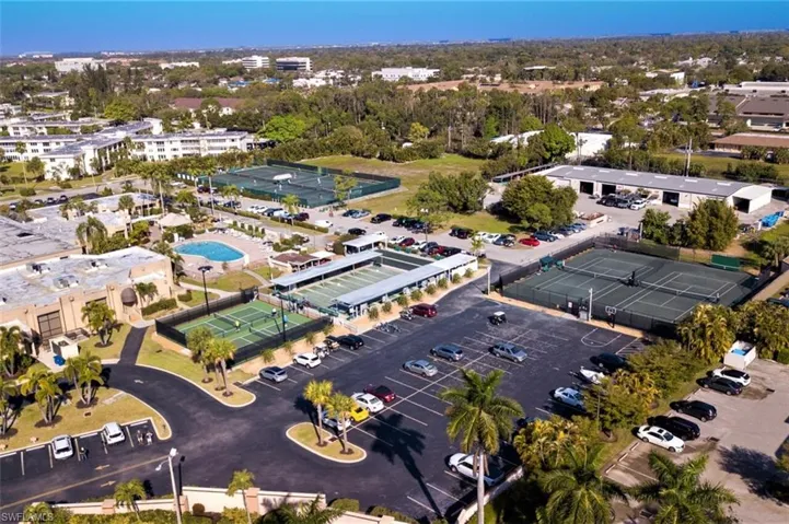 Aerial view of property and surrounding area featuring a pool