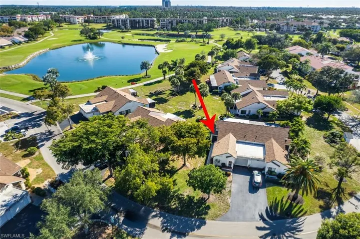 Aerial view of property's location with a nearby body of water, a golf club, and nearby suburban area