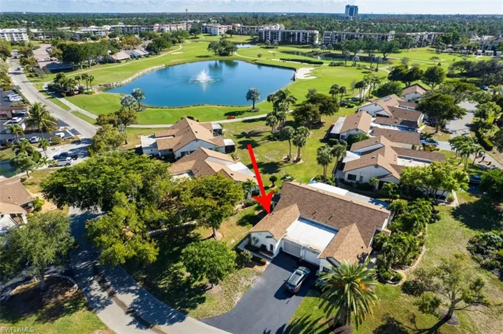 Aerial view of property's location with a nearby body of water and nearby suburban area