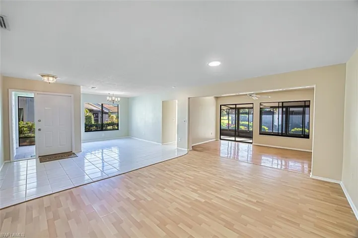 Unfurnished room with ceiling fan, a chandelier, light wood-type flooring, and recessed lighting