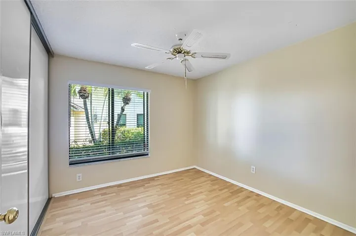 Spare room with light wood-style flooring, ceiling fan, and a textured ceiling