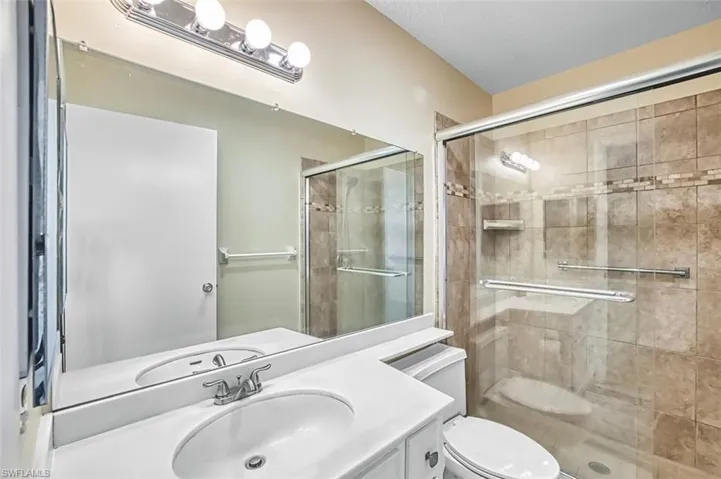 Bathroom featuring vanity and a stall shower