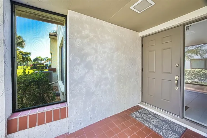 Property entrance featuring stucco siding