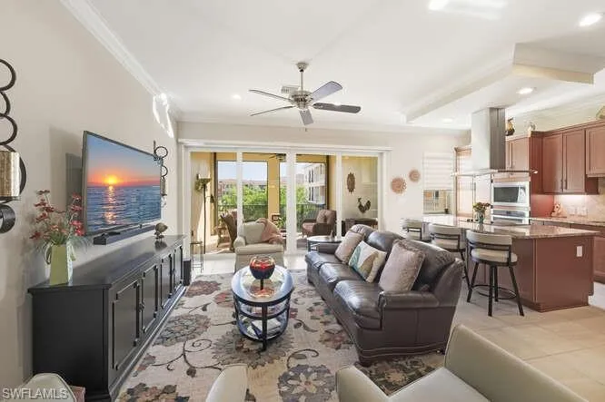 Living room featuring recessed lighting, light tile patterned flooring, crown molding, and ceiling fan