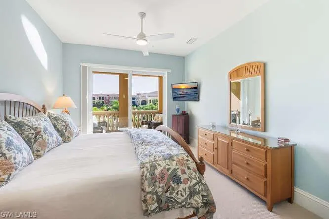 Bedroom featuring light carpet, access to outside, and a ceiling fan