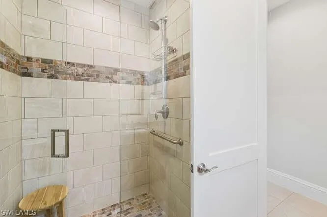 Full bathroom featuring a stall shower and light tile patterned floors