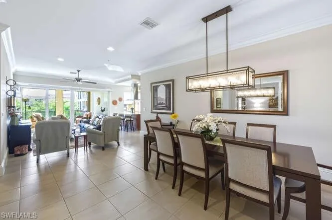 Dining space featuring crown molding, recessed lighting, light tile patterned flooring, and a ceiling fan