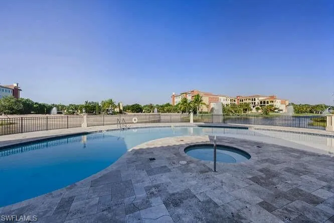 Community pool with a patio and a community hot tub