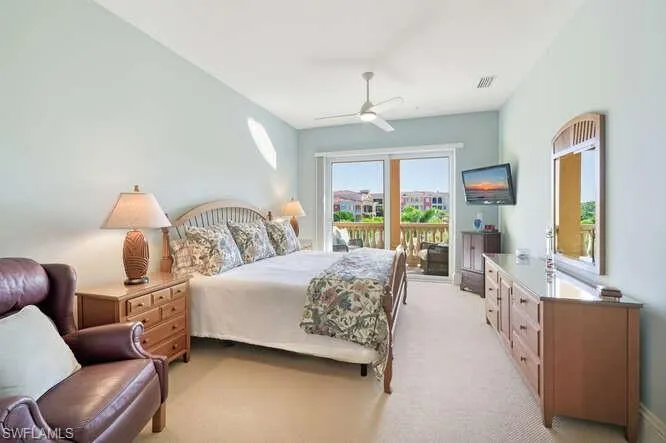 Bedroom with light carpet, access to outside, and a ceiling fan