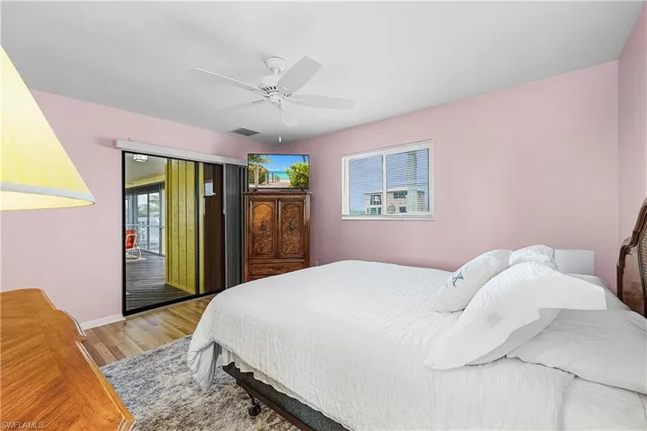 Bedroom featuring baseboards, visible vents, a ceiling fan, and light wood-style floors