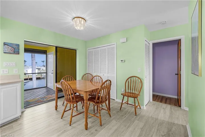 Dining area featuring light wood-style flooring and baseboards