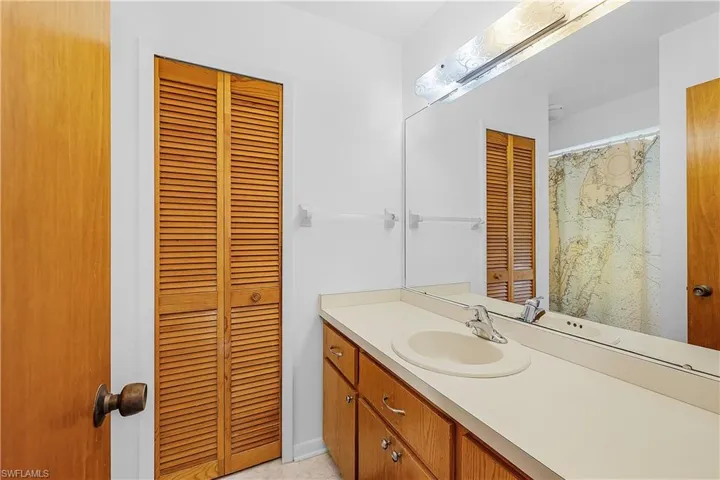 Bathroom featuring vanity and a closet
