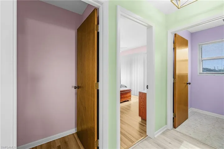 Hallway with baseboards and wood finished floors