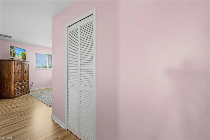 Hall featuring baseboards, visible vents, and light wood finished floors