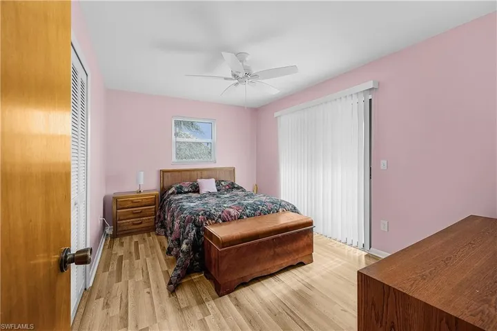 Bedroom featuring ceiling fan, baseboards, and light wood-style flooring