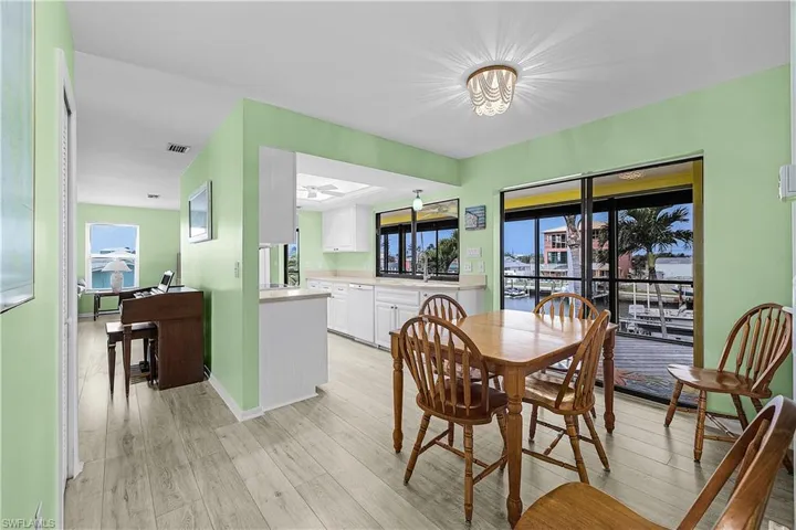Dining room featuring visible vents, a ceiling fan, light wood-type flooring, and baseboards