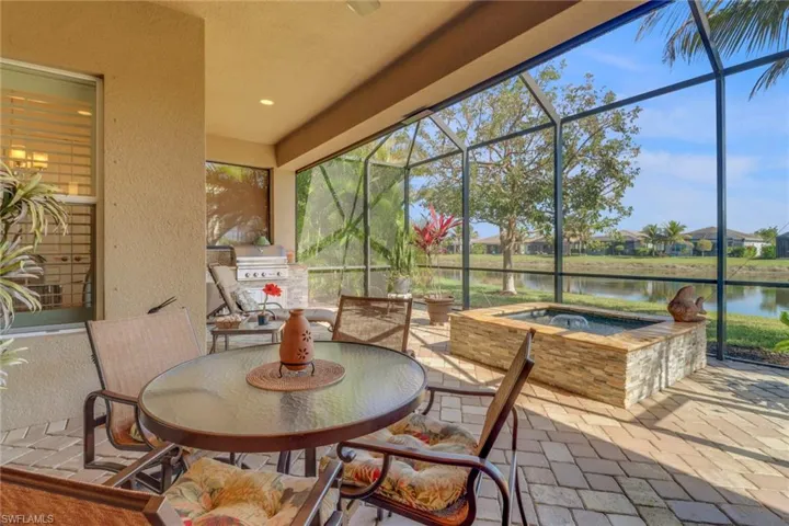 Sunroom / solarium featuring a water view