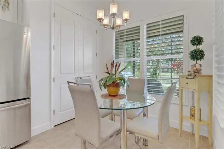 Tiled dining room with a notable chandelier