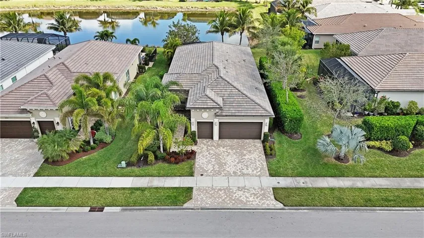 Birds eye view of property with a water view