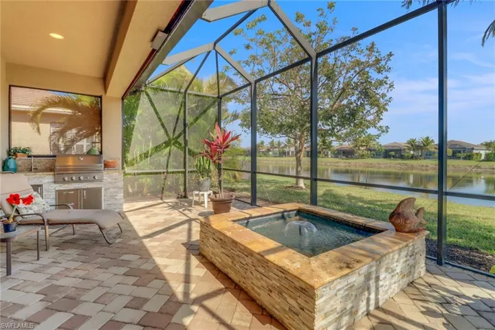 Sunroom / solarium with a water view and a jacuzzi