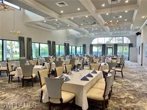 Dining room featuring a high ceiling, coffered ceiling, and beamed ceiling