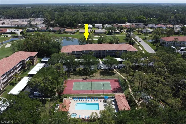 Birds eye view of property with a water view